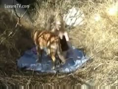 When she is outside, a skinny, golden-haired woman entices her dog to fuck her.
